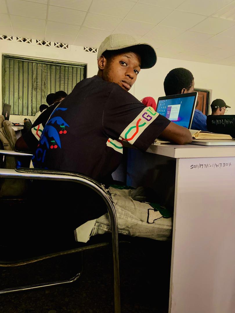 Jot Simeon working on a laptop in a creative workspace